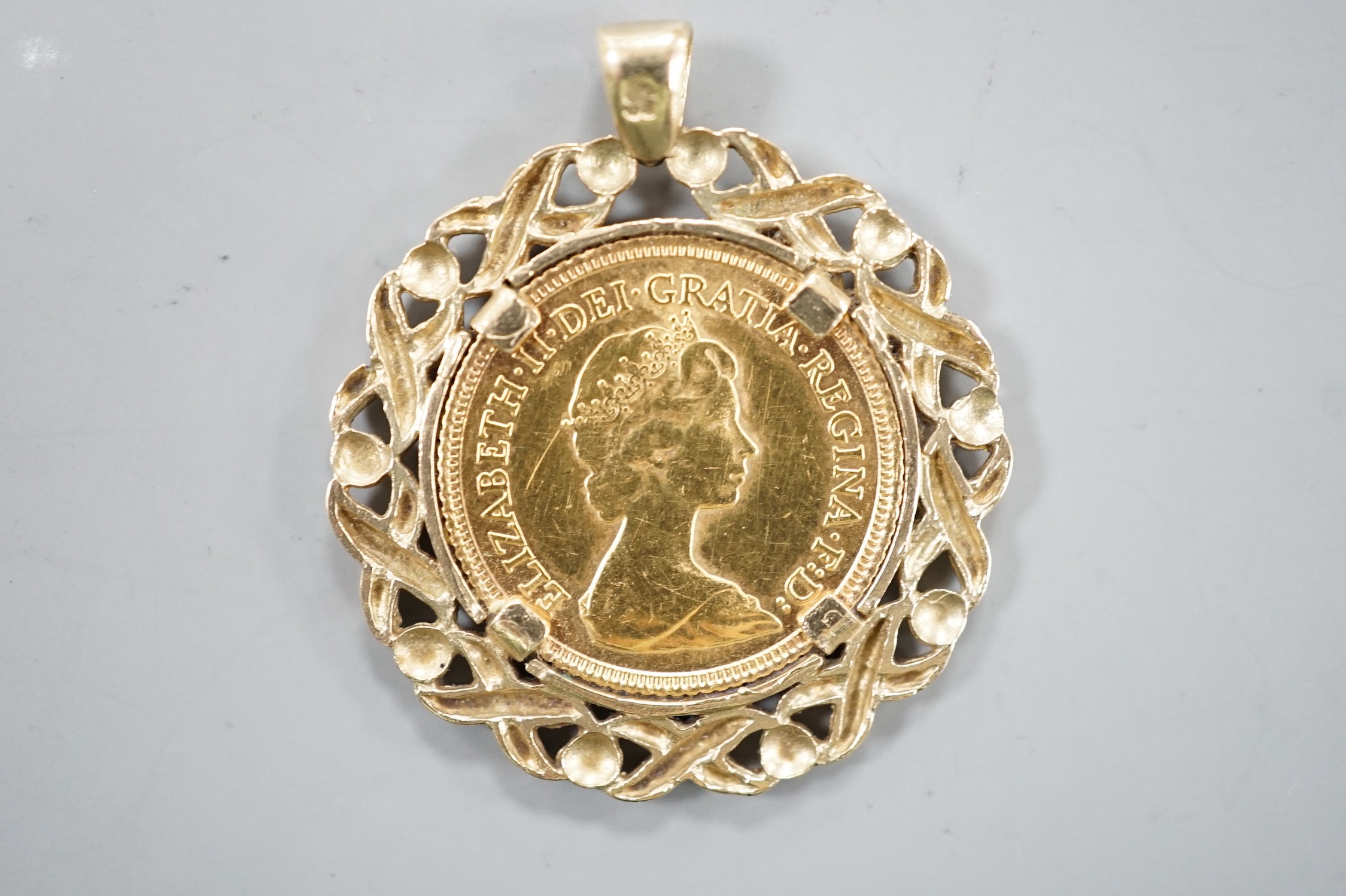 A Queen Elizabeth II 1982 gold half sovereign, now in a 9ct gold pendant mount, gross 7.9 grams.